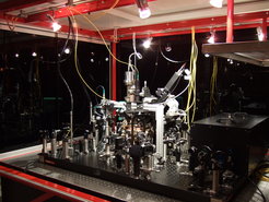 Experimental setup with vacuum chamber on an optical table.